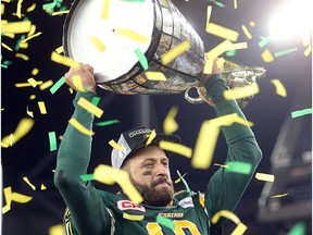 Edmonton Eskimos quarterback Mike Reilly hoists the Grey Cup after defeating the Ottawa RedBlacks 26-20 in CFL Grey Cup football in Winnipeg, Man. Sunday Nov. 29, 2015.