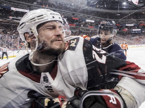 Arizona Coyotes ' Oliver Ekman-Larsson (23) is checked by Edmonton Oilers' Darnell Nurse (25) during first period NHL action at Rogers Place on Saturday January 12, 2019.