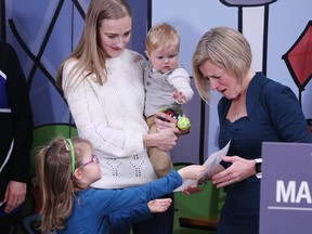 Premier Rachel Notley gets an impromptu drawing from Brooklyn McDaniel,4, after announcing the top baby names for 2018 as well as funding for midwife programs during a visit to the child care centre at Mount Royal University in Calgary on Tuesday, Jan. 15, 2019.