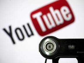 A webcam is positioned in front of YouTube's logo on June 28, 2013 in Paris.