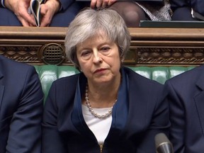 In this grab taken from video, Britain's Prime Minister Theresa May listens to Labour leader Jeremy Corbyn speaking after losing a vote on her Brexit deal, in the House of Commons, London, Tuesday Jan. 15, 2019.