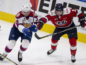Edmonton Oil Kings Josh Williams (34) and Lethbridge Hurricanes Calen Addison (2) battle fro the puck during first period WHL action on Sunday, Jan. 13, 2019  in Edmonton.