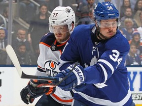 TORONTO, ON - FEBRUARY 27:  Auston Matthews #34 of the Toronto Maple Leafs tips a puck in front of Oscar Klefbom #77 of the Edmonton Oilers during an NHL game at Scotiabank Arena on February 27, 2019 in Toronto, Ontario, Canada.