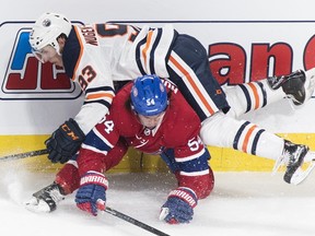 Edmonton Oilers' Ryan Nugent-Hopkins (93) collides with Montreal Canadiens' Charles Hudon during second period NHL hockey action in Montreal, Sunday, February 3, 2019.