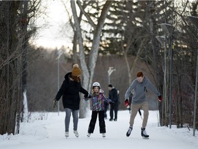 Michelle Nelson ice skates with her children Veronica Nelson, 8, and Spencer Nelson, 14, along the IceWay in Victoria Park in Edmonton Wednesday, Jan. 3, 2018. Photo by David Bloom