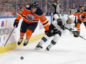 Edmonton Oilers' Milan Lucic (27) battles San Jose Sharks' Radim Simek (51) during the first period of a NHL game at Rogers Place in Edmonton, on Saturday, Feb. 9, 2019.