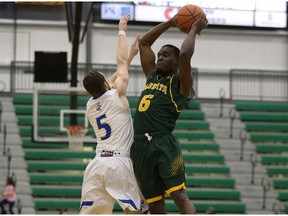 University of Alberta Golden Bears guard Dwan Williams (6) battles with the University of Lethbridge Pronghorns' Kyle Peterson (5) during quarter-final Canada West basketball playoffs at the Saville Centre, in Edmonton Friday Feb. 15, 2019.