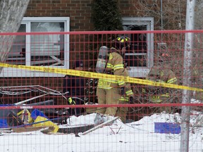 Fire crews work near the scene of an explosion along 97A Street north of Griesbach Road, in Edmonton Saturday Feb. 23, 2019.