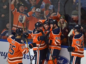 Edmonton Oilers Connor McDavid, (centre) celebrating his overtime goal with teammates defeating the New York Islanders 4-3 during NHL action at Rogers Place in Edmonton, February 21, 2019.