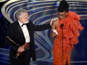 Jay Hart, left, and Hannah Beachler accept the award for best production design for "Black Panther" at the Oscars on Sunday, Feb. 24, 2019, at the Dolby Theatre in Los Angeles.
