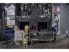 Firefighters investigate following the house fire in Halifax.