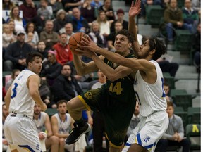 University of Alberta Golden Bears' Brody Clarke (14) battles the University of Lethbridge Pronghorns' Keanu Funa (22) during quarter-final Canada West basketball playoffs at the Saville Centre, in Edmonton Friday Feb. 15, 2019.