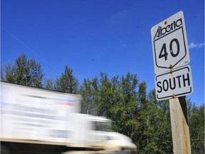 File: Motorists drive past a Highway 40 sign south of Grande Prairie, Alta.