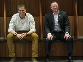 Edmonton Eskimos newly acquired quarterback Trevor Harris (left) sits in the team dressing room at Commonwealth Stadium with general manager Brock Sunderland (right) on Thursday February 14, 2019.