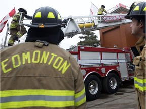 Edmonton Fire Fighters climb onto the roof of Fire Station #2 (10217 107 St.) as they start their annual Rooftop Campout to raise awareness and funds in support of Muscular Dystrophy Canada, in Edmonton Tuesday, Feb. 21, 2017.