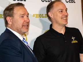 Edmonton Stingers president Lee Genier, left, introduces new coach and general manager Barnaby Craddock at a news conference on Wednesday, Feb. 20, 2019.