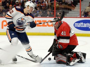 Ottawa Senators goalie Craig Anderson makes a save under pressure from Edmonton Oilers' Colby Cave during first period NHL action in Ottawa, Thursday, Feb. 28, 2019.