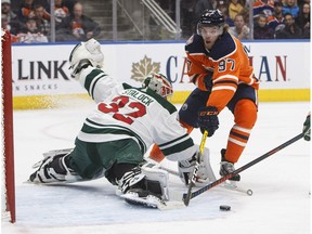 Minnesota Wild goaltender Alex Stalock (32) makes the save on Edmonton Oilers center Connor McDavid (97) during second period NHL action in Edmonton, Alta., on Friday December 7, 2018.