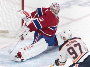 Edmonton Oilers' Connor McDavid moves in on Montreal Canadiens goaltender Carey Price during overtime period NHL hockey action in Montreal, Sunday, February 3, 2019.