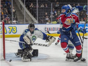 Liam Keeler of the Oil Kings watches the puck drift wide of the net and goalie Riley Lamb the Swift Current Broncos at Rogers Place on February 26, 2019. Shaughn Butts / Postmedia