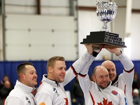 The winning rink of Kevin Koe hold up the trophy after winning the championship game of the 2019 Alberta Boston Pizza Cup Men's Curling Championship between the Appelman and Koe rinks at Ellerslie Curling Club in Edmonton, on Sunday, Feb. 10, 2019.