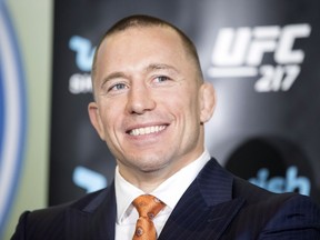 Canadian fighter Georges St-Pierre attends a news conference, held wi with British fighter Michael Bisping in Toronto to promote UFC 217 on Friday October 13, 2017.