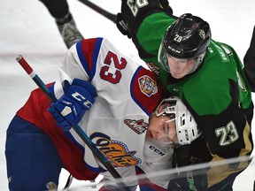 Edmonton Oil Kings' Jalen Luypen (23) gets held down by Prince Albert Raiders' Eric Pearce after a face-off at Rogers Place in Edmonton on Feb. 4, 2019.