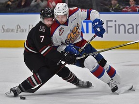 Edmonton Oil Kings Andrew Fyten (39) gets held back by Red Deer Rebels Carson Sass (7) during WHL action at Rogers Place in Edmonton, February 22, 2019. Ed Kaiser/Postmedia