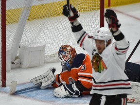 Chicago Blackhawks Artem Anisimov (15) celebrates a goal score by Patrick Kane (88) on Edmonton Oilers goalie Cam Talbot (33) who was pulled from the game after that during NHL action at Rogers Place in Edmonton, February 5, 2019.