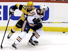 Pittsburgh Penguins' Sidney Crosby (87) defends against Edmonton Oilers' Connor McDavid (97) during the first period of an NHL hockey game in Pittsburgh, Wednesday, Feb. 13, 2019.