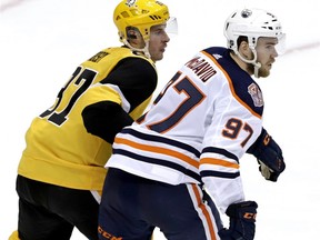 Pittsburgh Penguins' Sidney Crosby (87) and Edmonton Oilers' Connor McDavid play during the third period of an NHL hockey game in Pittsburgh, Wednesday, Feb. 13, 2019. The Penguins won 3-1.