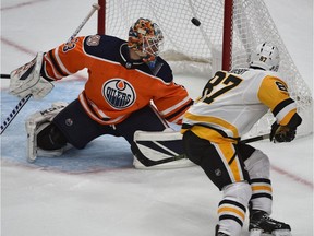 Pittsburgh Penguins Sidney Crosby (87) lifts the puck over Edmonton Oilers goalie Cam Talbot to score in overtime during NHL action at Rogers Place in Edmonton, October 23, 2018.