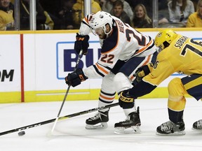 Edmonton Oilers right wing Tobias Rieder (22), of Germany, and Nashville Predators defenseman P.K. Subban (76) battle for the puck in the first period of an NHL hockey game Monday, Feb. 25, 2019, in Nashville, Tenn.