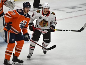 Former Oiler now Chicago Blackhawks Drake Caggiula (91) is his first game back since being traded here being guarded by Edmonton Oilers Oscar Klefbom (77) during NHL action at Rogers Place in Edmonton, February 5, 2019.