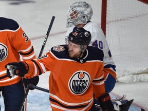 Edmonton Oilers Leon Draisaitl (29) gestures to Connor McDavid for passing the puck to him, enabling him to score on New York Islanders goalie Robin Lehner (40) during NHL action at Rogers Place in Edmonton, February 21, 2019. Ed Kaiser/Postmedia