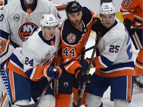 Edmonton Oilers Zack Kassian (44) gets double teamed by New York Islanders Scott Mayfield (24) and Devon Toews (25) during NHL action at Rogers Place in Edmonton, Feb. 21, 2019.