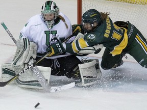 University of Alberta Pandas' Amy Boucher (13) is stopped by the Saskatchewan Huskies' goalie Jessica Vance (30) during Game 2 of their semifinal series, in Edmonton Saturday Feb. 23, 2019.