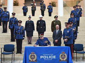 Signing to make it official, Dale McFee becomes the city's 23rd EPS chief of police during a swearing-in ceremony at City Hall in Edmonton, February 1, 2019.