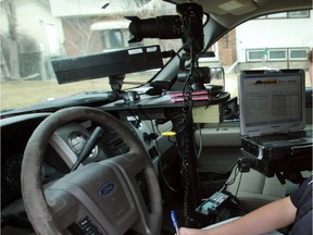 An Edmonton peace officer operates a photo radar unit.