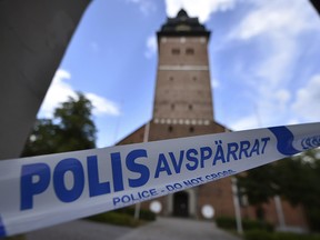 In this file photo dated Tuesday, July 31, 2018, a police cordon near the scene of a robbery at the Strangnas Cathedral, in Strangnas, Sweden, after priceless treasures from the Swedish royal regalia were stolen. (Pontus Stenberg/TT News Agency FILE via AP)
