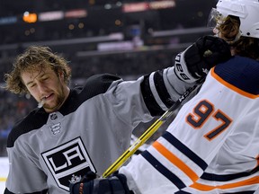 LOS ANGELES, CALIFORNIA - JANUARY 05:  Brendan Leipsic #14 of the Los Angeles Kings pushes Connor McDavid #97 of the Edmonton Oilers during the third period in a 4-0 Kings win at Staples Center on January 05, 2019 in Los Angeles, California. (Photo by Harry How/Getty Images)