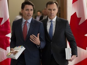 Prime Minister Justin Trudeau and Finance Minister Bill Morneau speak as they walk to the House of Commons in Ottawa, Tuesday March 19, 2019. THE CANADIAN PRESS