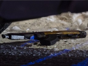 What appears to be a gun lays on the ground at the scene of an officer involved shooting near 79 Avenue and 71 Street, in Edmonton Wednesday Dec. 26, 2018. Photo by David Bloom