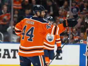 Edmonton Oilers' Zack Kassian (44) celebrates Matt Benning's (83) goal on New York Rangers' goaltender Alexandar Georgiev (40) during the first period of a NHL game at Rogers Place in Edmonton, on Monday, March 11, 2019.