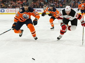 Edmonton Oilers' Darnell Nurse (25) races New Jersey Devils' Stefan Noesen (23) during the first period of a NHL game at Rogers Place in Edmonton, on Wednesday, March 13, 2019.