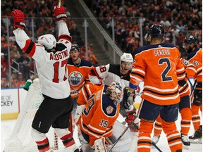 New Jersey Devils' Kenny Agostino (17) celebrates a goal on Edmonton Oilers' goaltender Mikko Koskinen (19) during the first period of a NHL game at Rogers Place in Edmonton, on Wednesday, March 13, 2019.