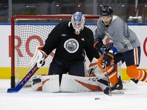 Anthony Stolarz (32) Andrej Sekera (2) take part in an Edmonton Oilers practice at Rogers Place, in Edmonton Monday March 25, 2019.