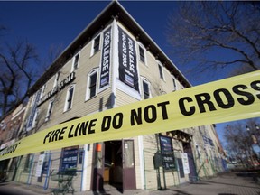 Tape is strung in front of the Strathcona Hotel in Edmonton on March 30, 2019. Fire investigators are on scene after an overnight blaze saw up to 40 firefighters on scene.