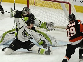 Medicine Hat Tigers Ryan Chyzowski (right) shoots the puck past Edmonton Oil Kings Will Warm and goalie Dylan Myskiw to score during second period WHL hockey game action at Rogers Place on Friday March 1, 2019.