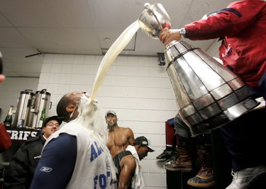 Montreal Alouettes' Raymond Fontaine gets a drink from the Grey Cup after winning the 98th Grey Cup held at Commonwealth Stadium in Edmonton on Sunday November 28, 2010. PERRY MAH/EDMONTON SUN